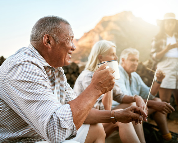 group of senior friends sitting together after hiking annuity for retirement options